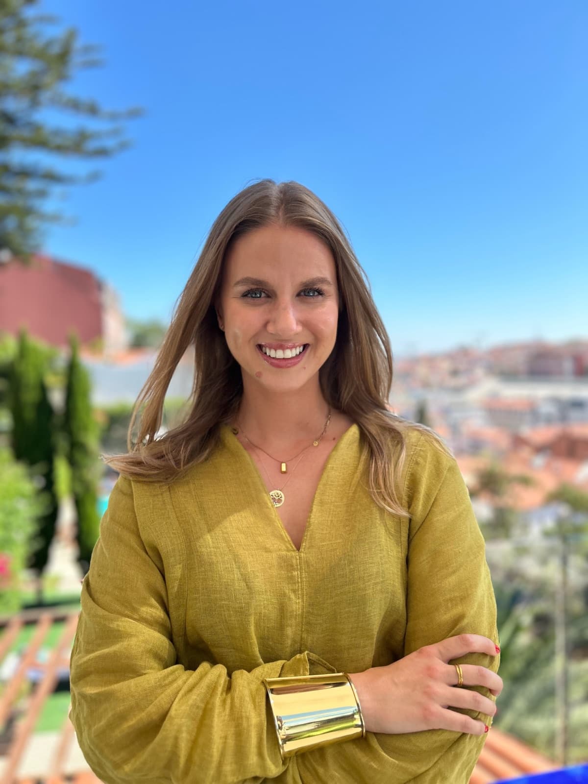 Cristina Sebe, fractional growth lead, smiling on a rooftop overlooking Lisbon